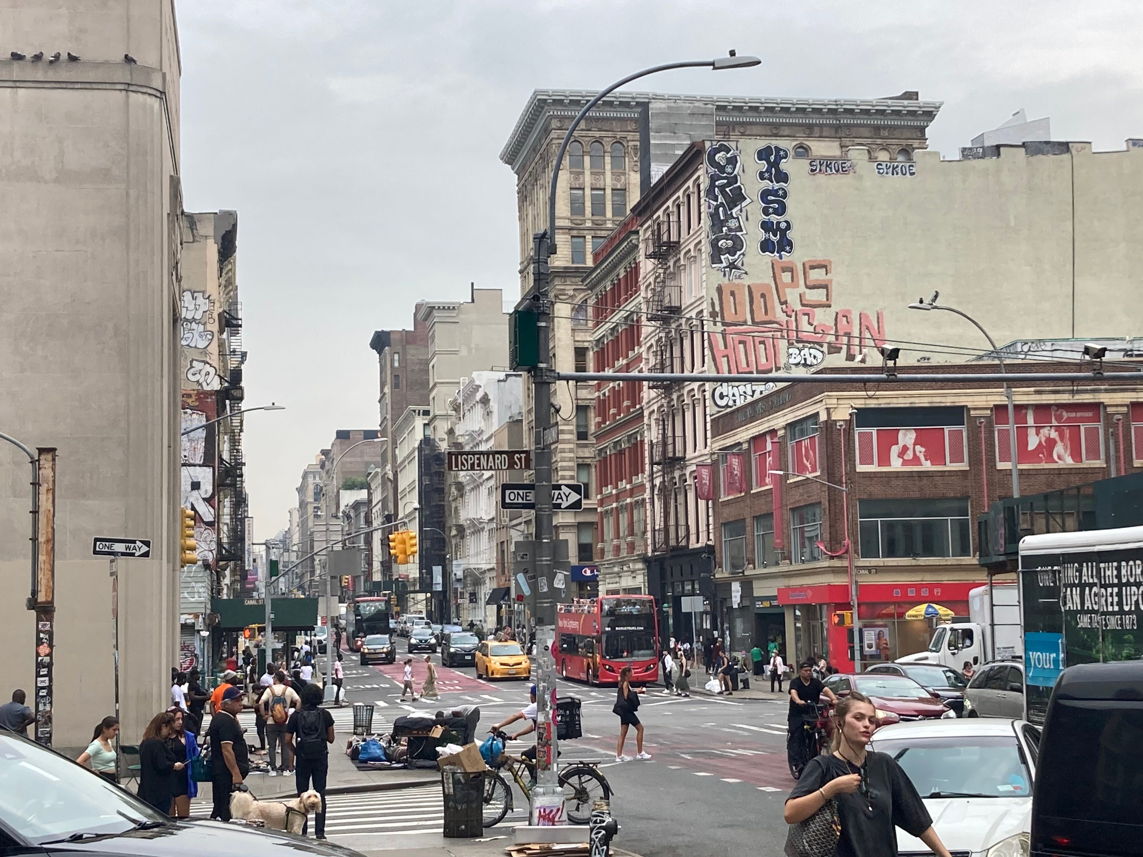 the view looking north from Broadway toward Canal Street, Oops Hooligan spraypainted on the side of a nearby building