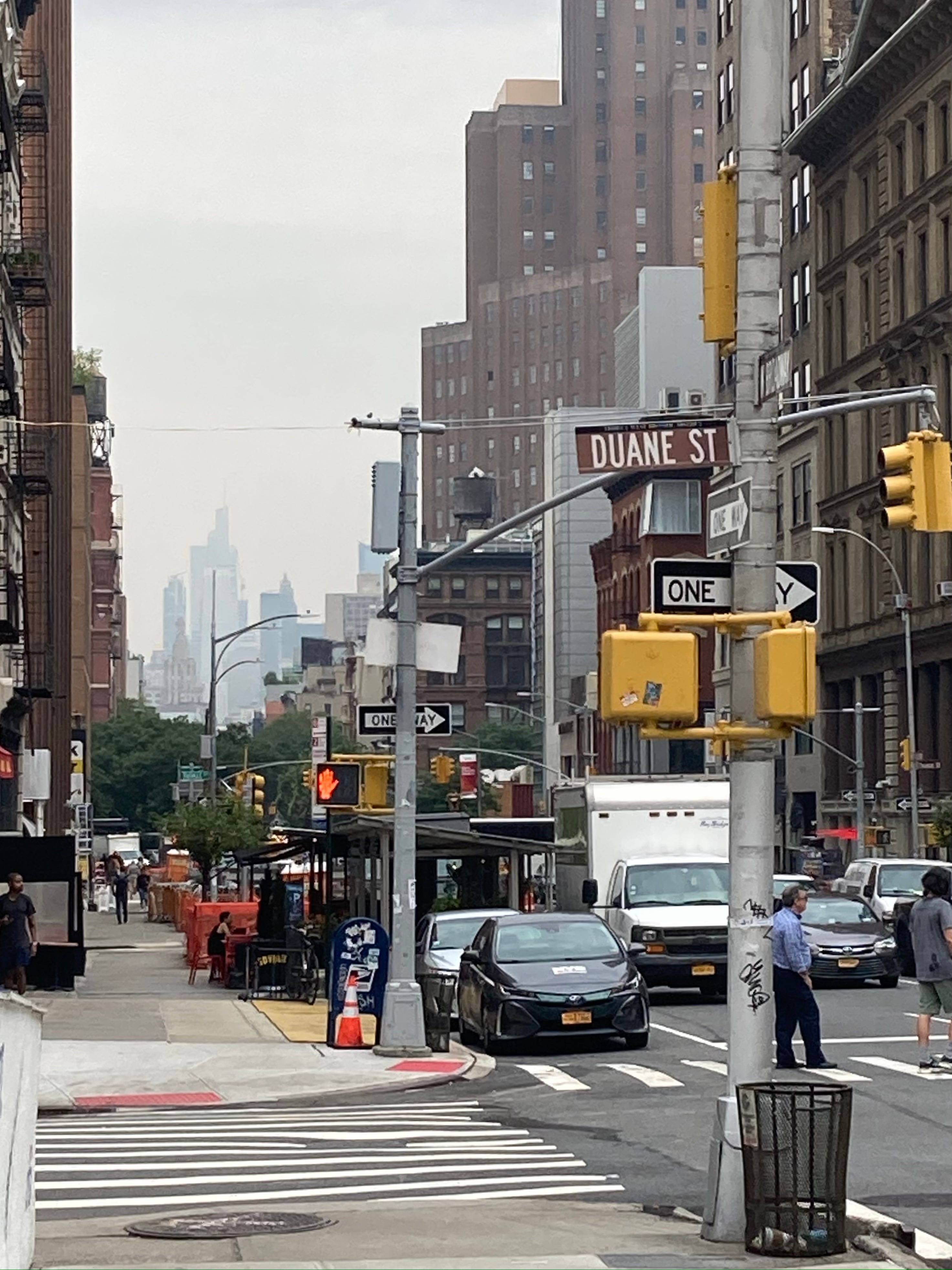 hazy view of midtown buildings as seen from the corner of Duane St and West Broadway